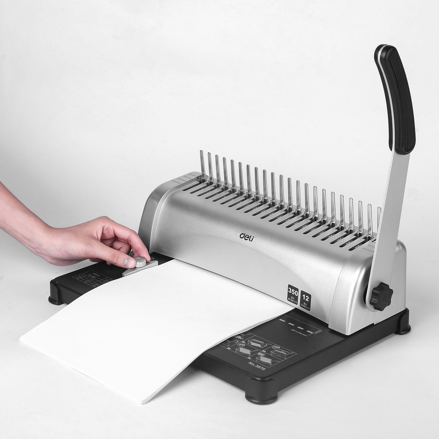 Person using a manual paper trimmer on a white background Deli E3870 Comb Binding Machine